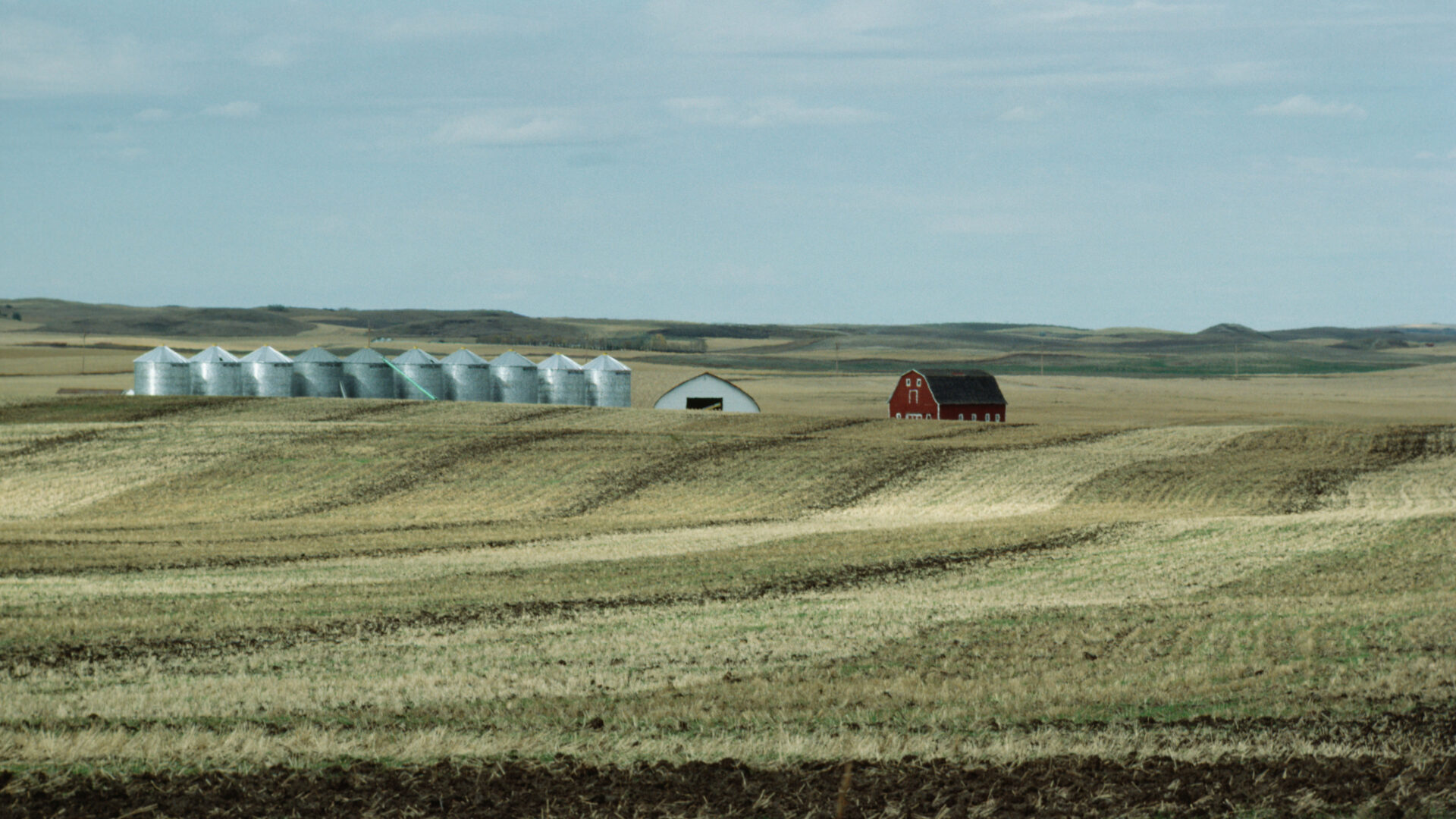Landscape image of a farmers field with a bar. From Photos.com